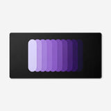 Gradient Capsule Desk Pad in Purple, with overlapping rounded bars on a black background