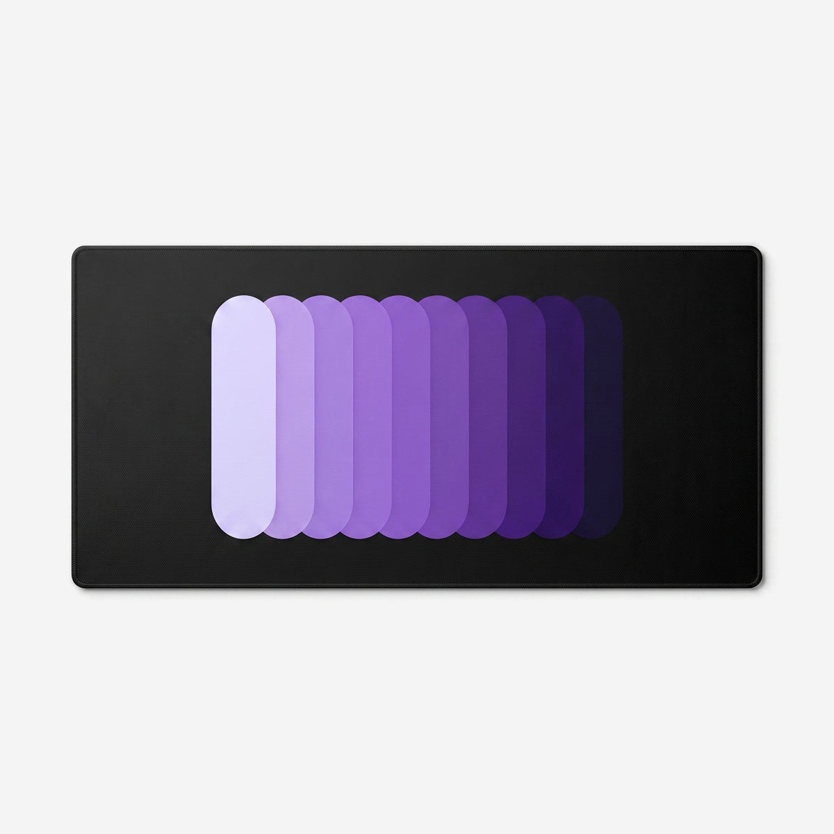 Gradient Capsule Desk Pad in Purple, with overlapping rounded bars on a black background