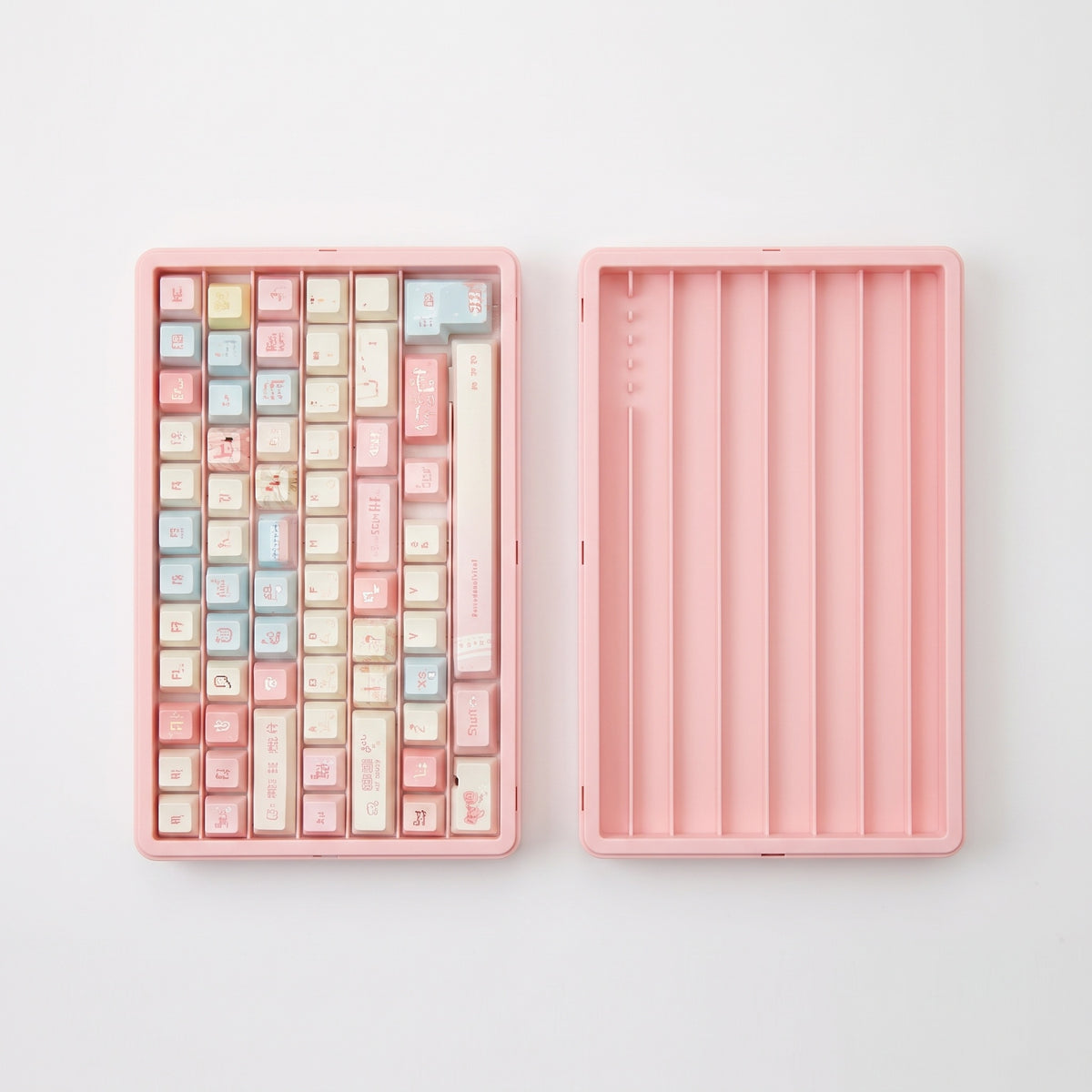 Pink ABS keycap storage box shown open with demonstration keycaps; keycaps not included
