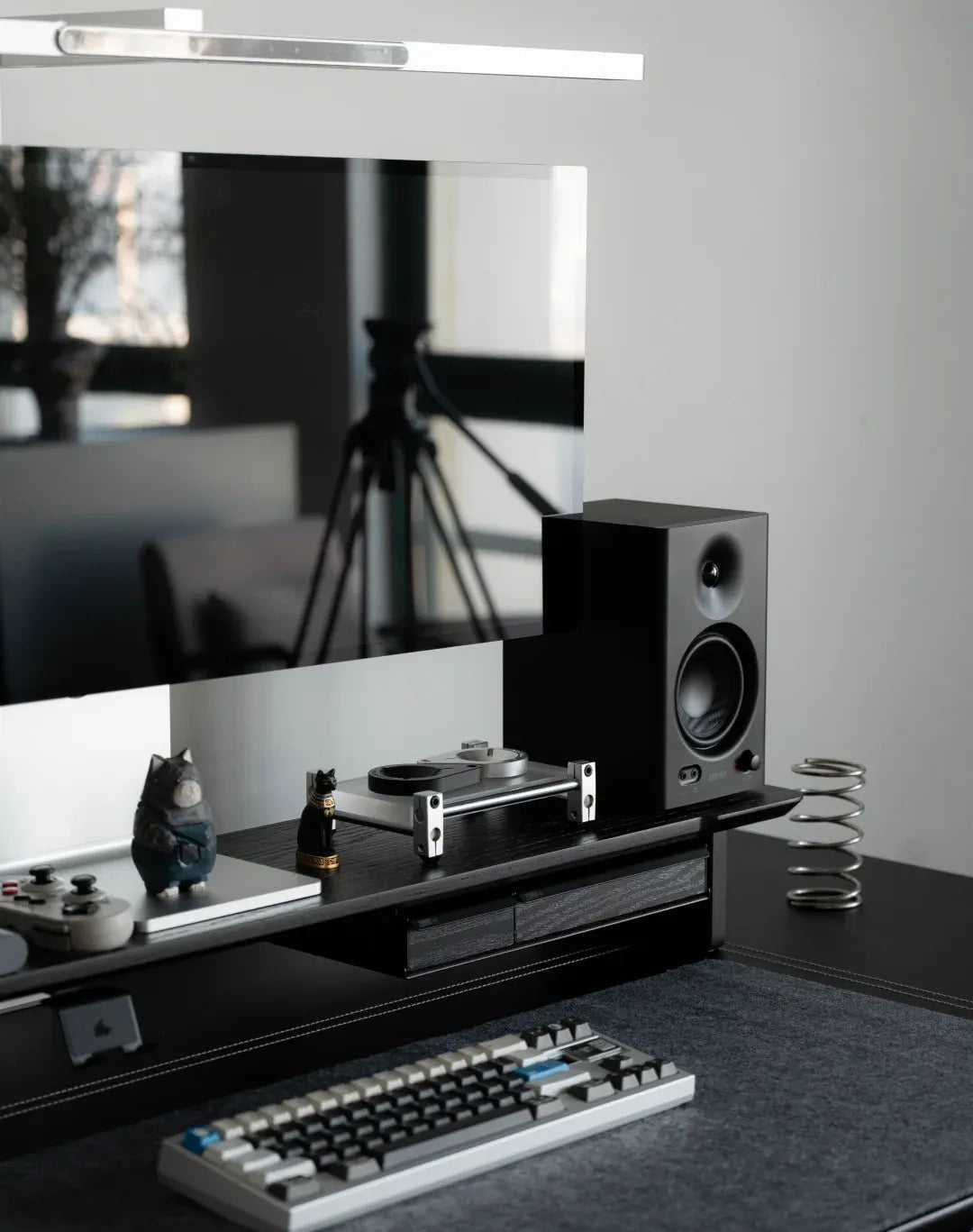 Lift the display onto a riser so the keyboard and desk mat stay clear.