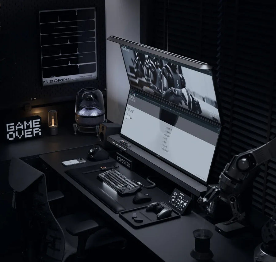 Stack a second display above the first so the desk surface stays clear for hands-on gear.