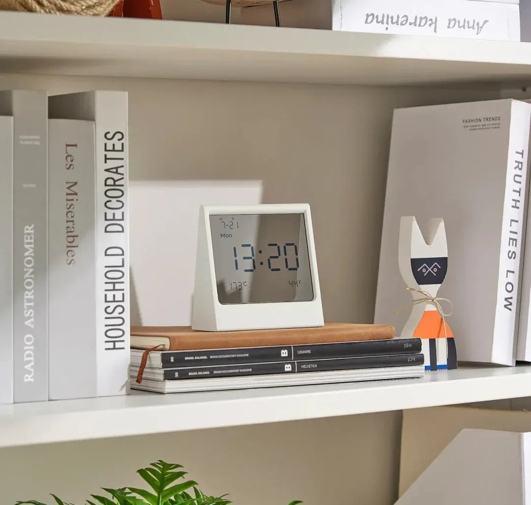 Set the small trapezoid clock on a bookshelf between books and decor for a neutral, readable accent.