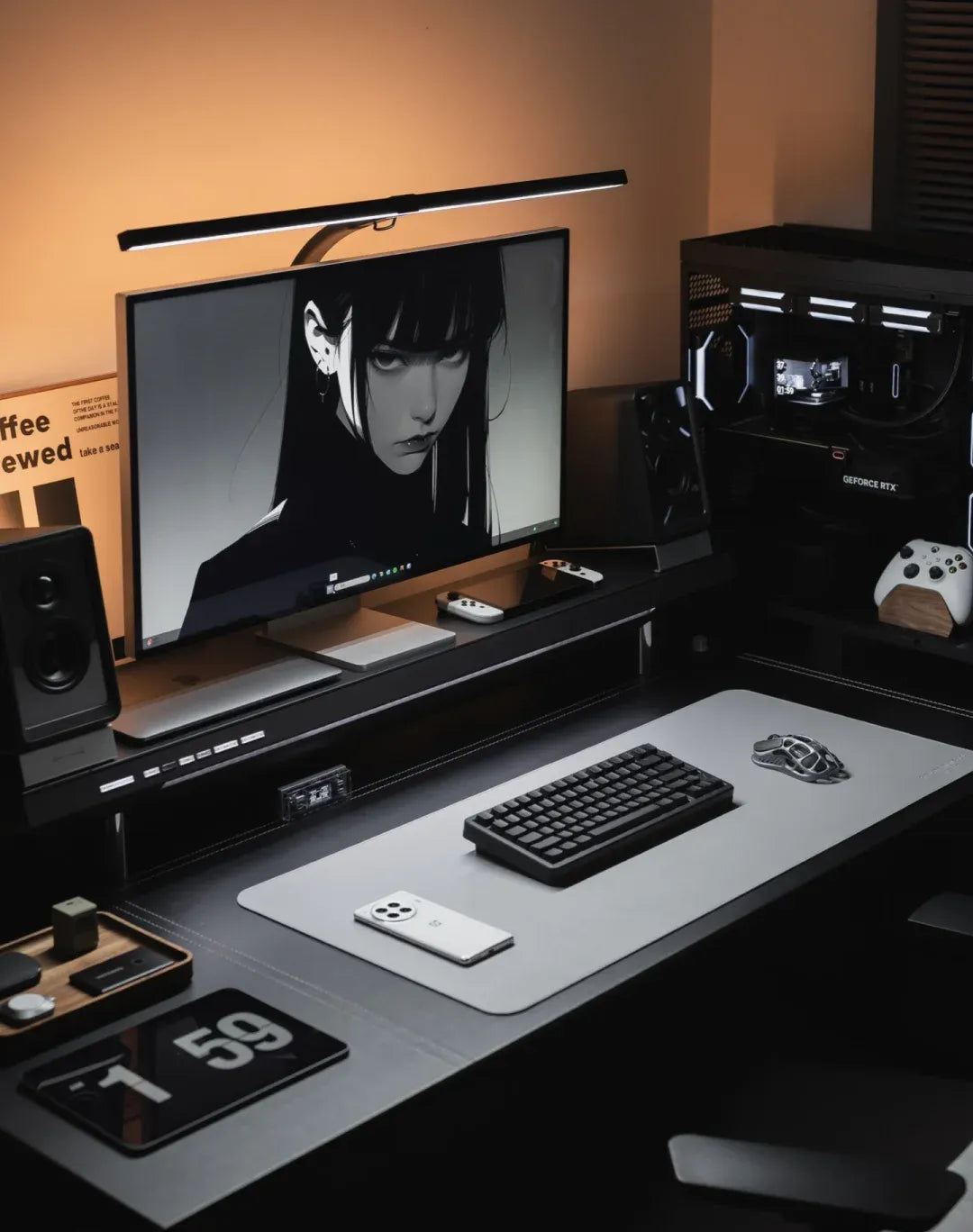 Anchor the desk with a black-and-white anime portrait, then let warm side light soften the cold linework.
