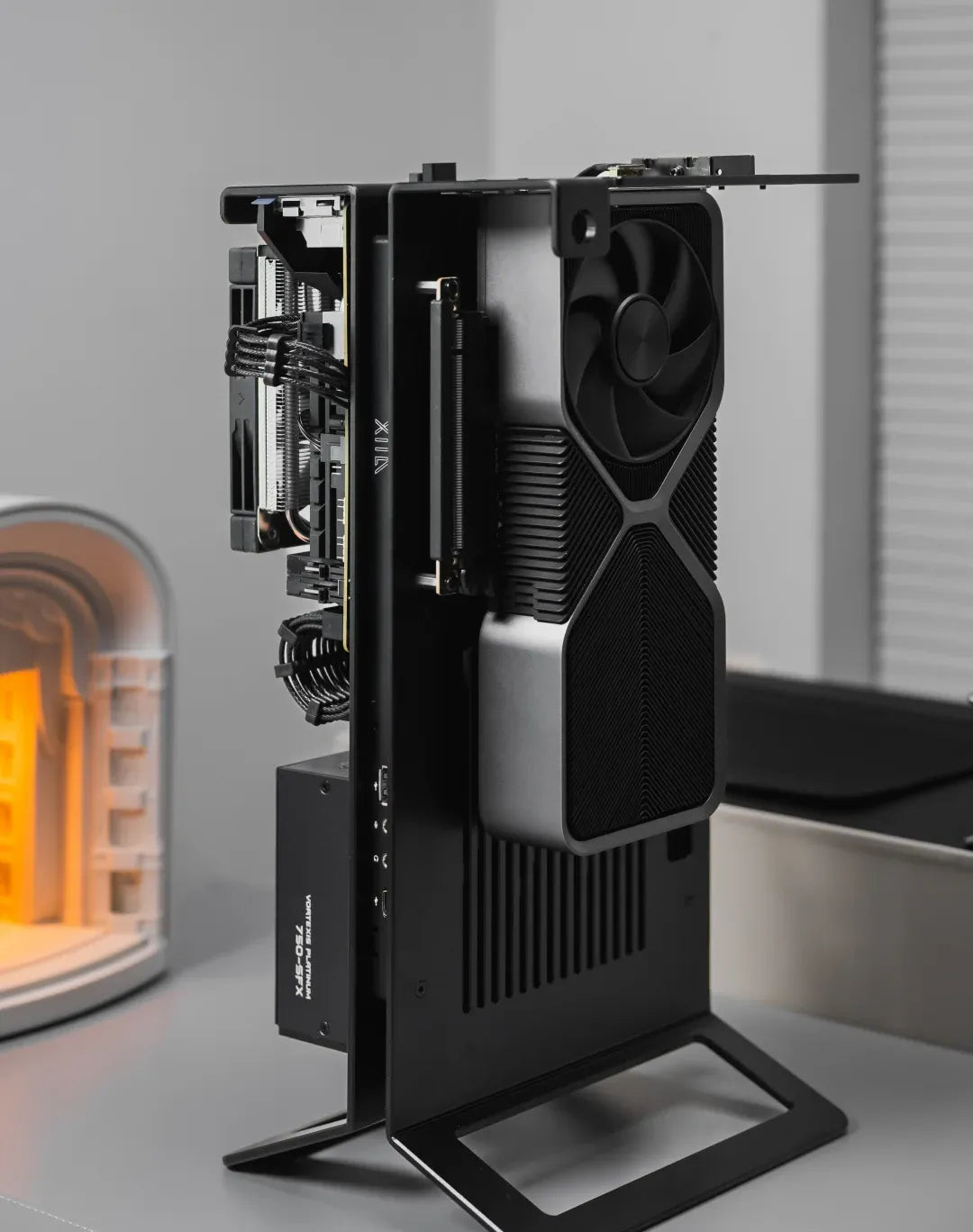 Stand the frame on its aluminum feet so the graphics card faces the room.