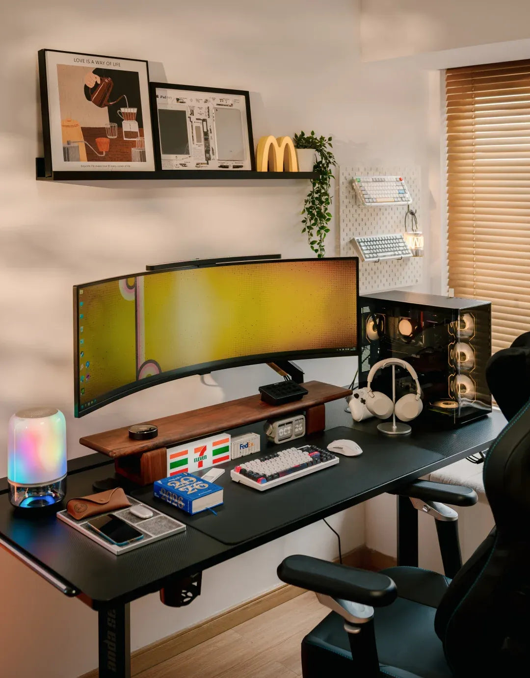 Raise the ultrawide on an arm so the desktop stays free for keyboard and headphones.