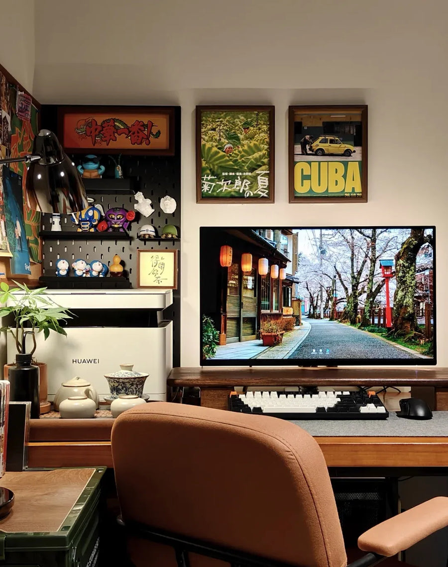 Keep the things you love within arm's reach: figures, tea, posters, and a warm chair share one corner.