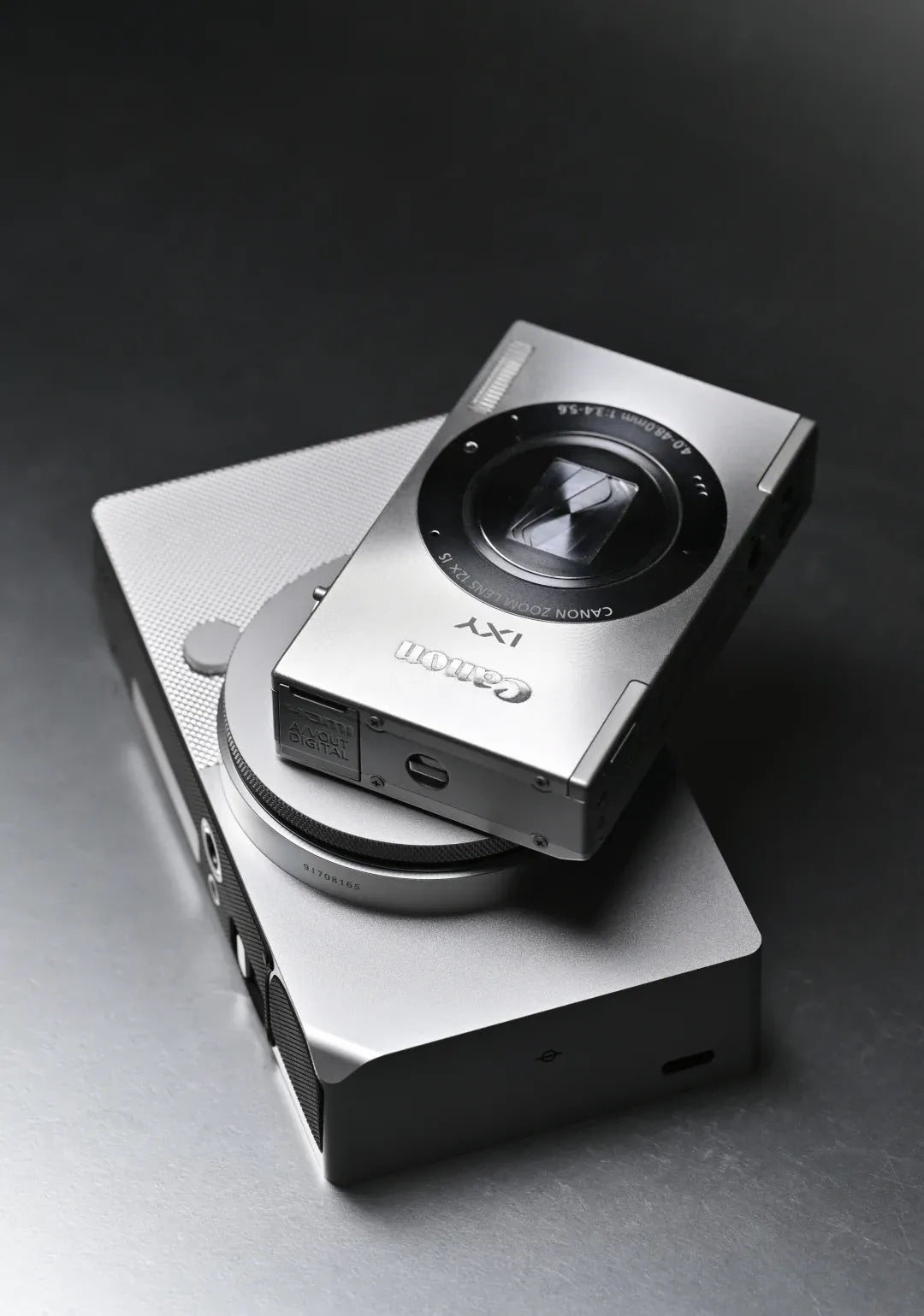 Stack the Sigma BF and Canon IXY 3 to compare their metal bodies side by side.
