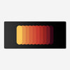 Gradient Capsule Desk Pad in Orange, with overlapping rounded bars on a black background