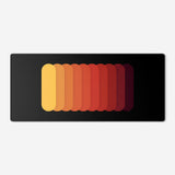 Gradient Capsule Desk Pad in Orange, with overlapping rounded bars on a black background