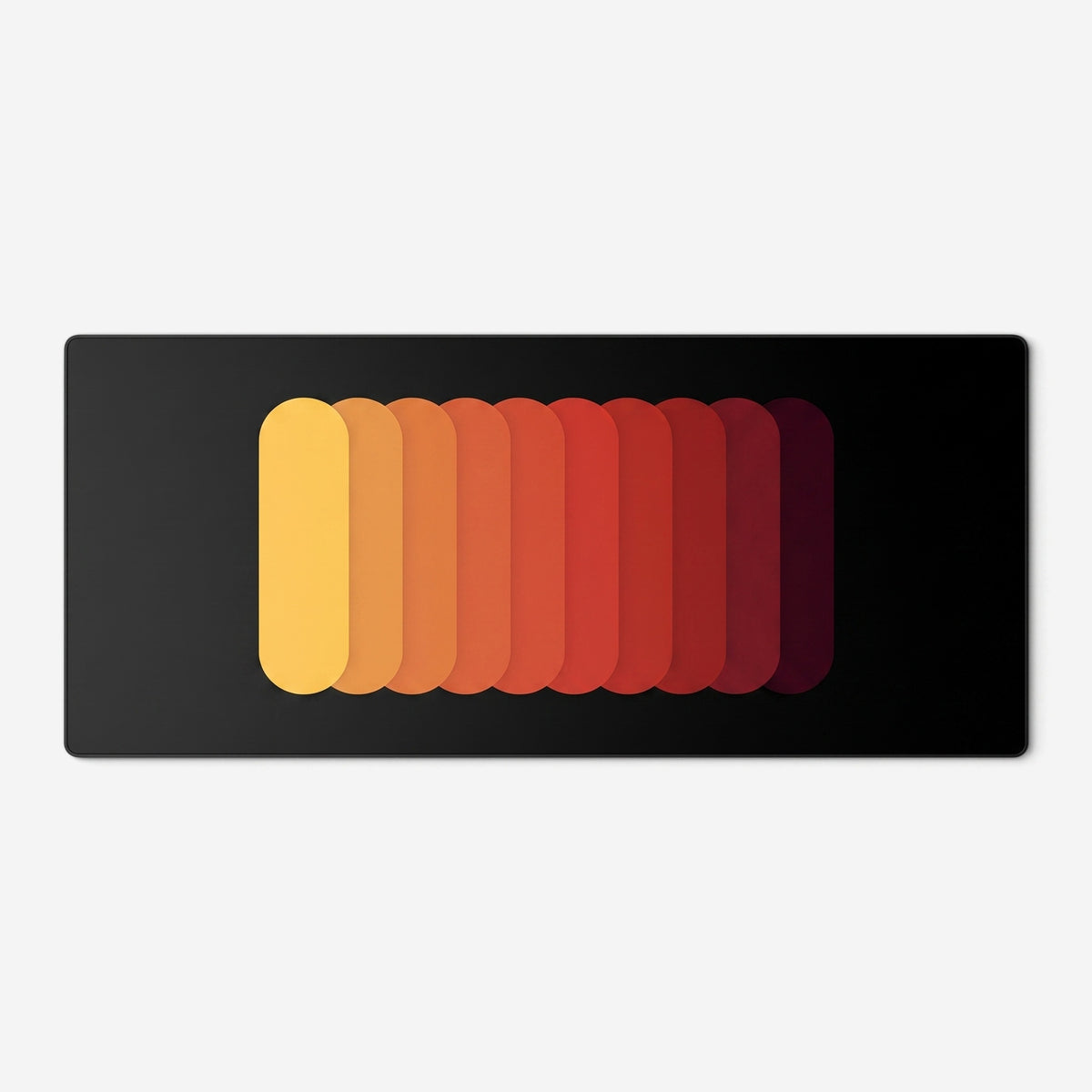 Gradient Capsule Desk Pad in Orange, with overlapping rounded bars on a black background